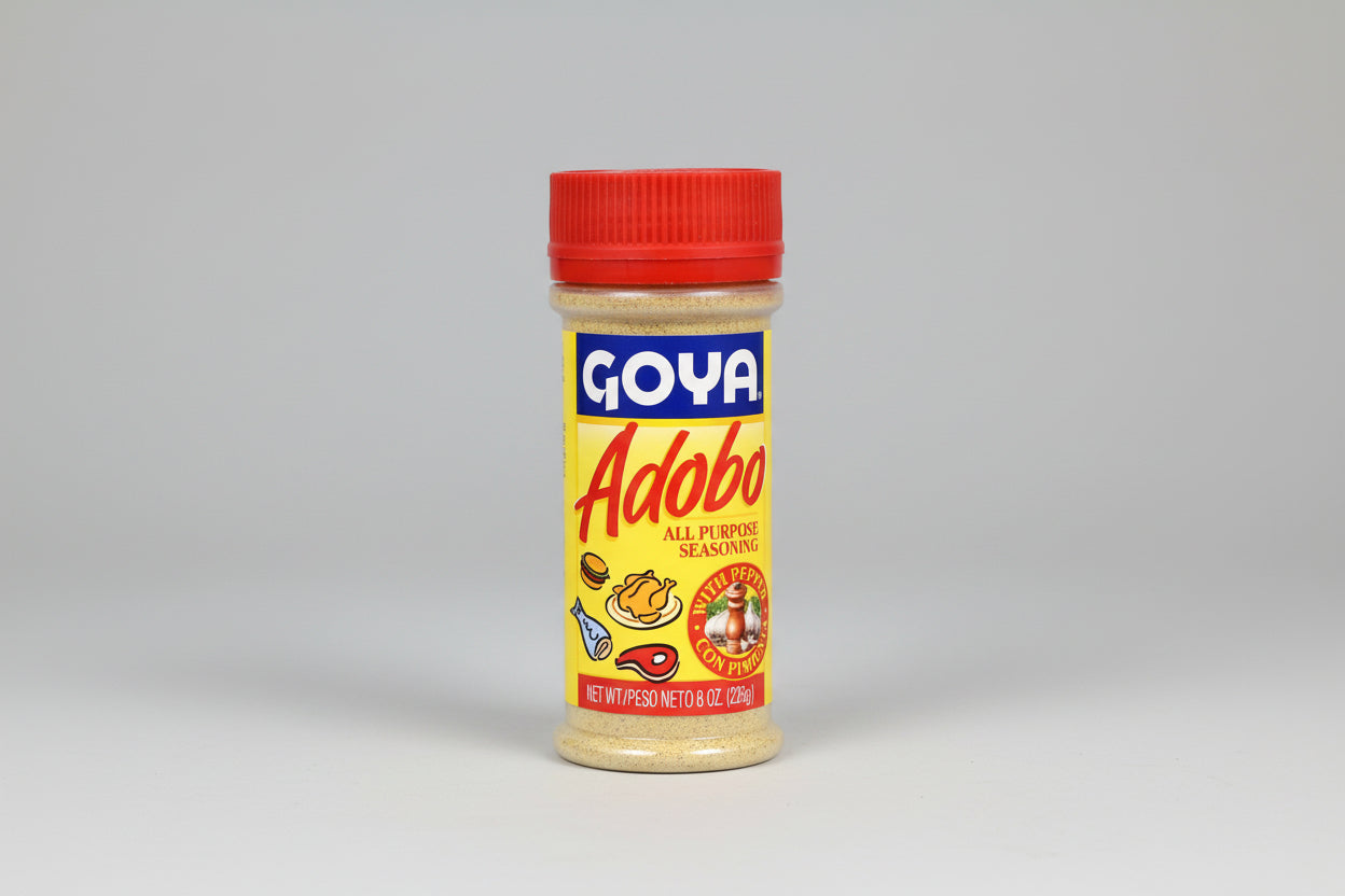 A bottle of Goya Adobo All Purpose Seasoning With Pepper, 226g size, displaying the brand logo, product name, and an illustration of foods seasoned with the product.