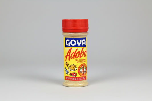 A bottle of Goya Adobo All Purpose Seasoning With Pepper, 226g size, displaying the brand logo, product name, and an illustration of foods seasoned with the product.